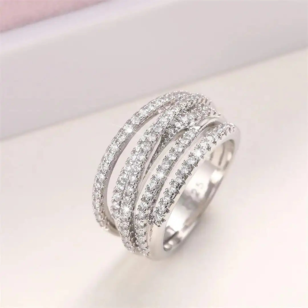 Layered ring with a cross and zircons