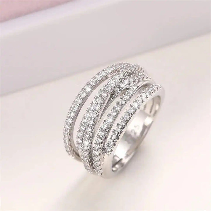 Layered ring with a cross and zircons