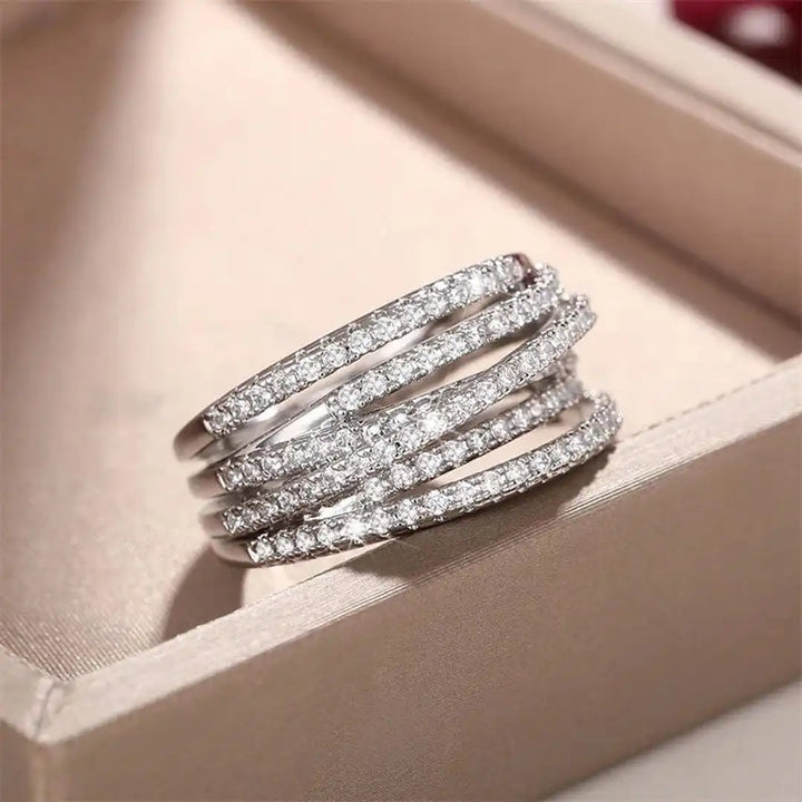 Layered ring with a cross and zircons