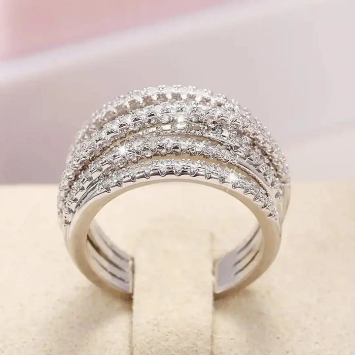 Layered ring with a cross and zircons