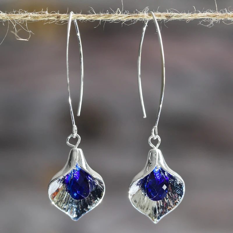 Silver-toned earrings with a blue stone