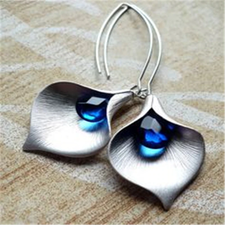 Silver-toned earrings with a blue stone